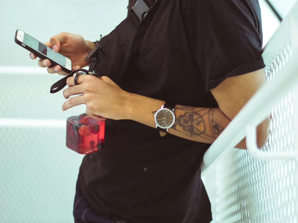A tradesperson checking their phone on site